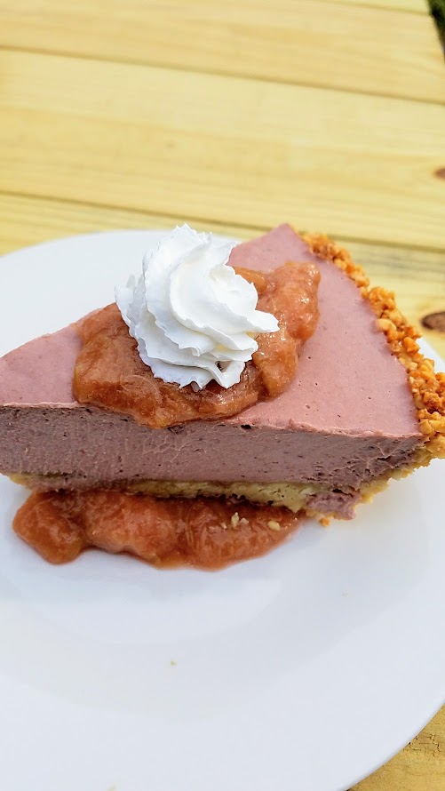 Of Roots and Blooms pops up every Wednesday at Bottles on Fremont and Sundays at Culmination Brewing offering rotating vegan delights. This Of Roots and Blooms vegan food example is their Vegan Strawberry Cheesecake with rhubarb sauce