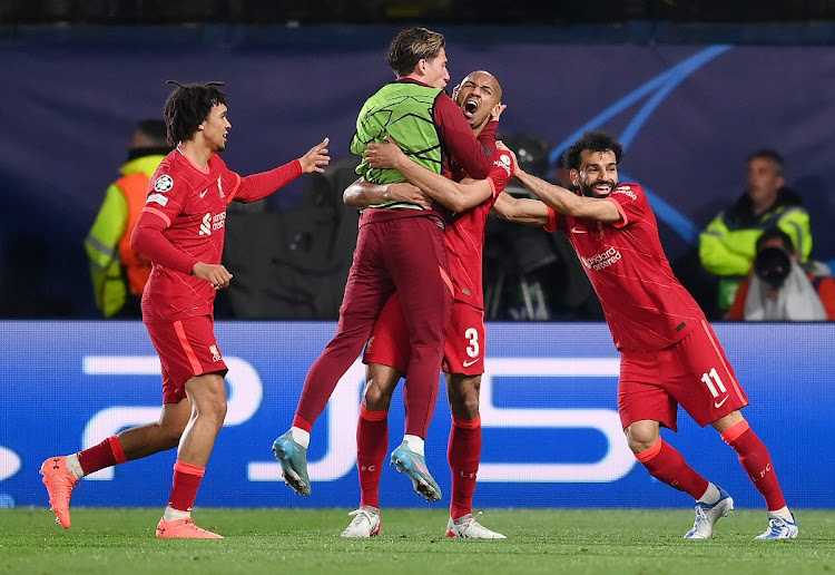 Fabinho celebrates with teammates Kostas Tsimikas, Mohamed Salah and Trent Alexander-Arnold of Liverpool after scoring their team's first goal in the Uefa Champions League semifinal second leg against Villarreal at Estadio de la Ceramica in Villarreal, Spain on May 3 2022.