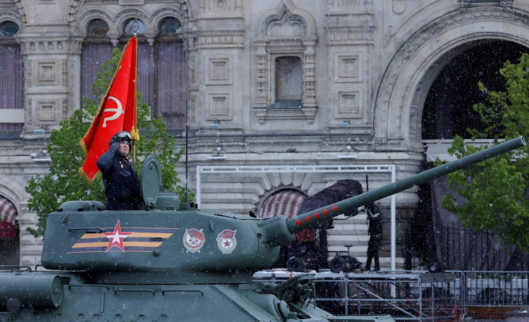 A Russian service member rides on a T-34 Soviet-era tank during a military parade on Victory Day, which marks the 79th anniversary of the victory over Nazi Germany in World War 2, in Red Square in Moscow, Russia, on May 9, 2024. Picture: REUTERS/MAXIM SHEMETOV