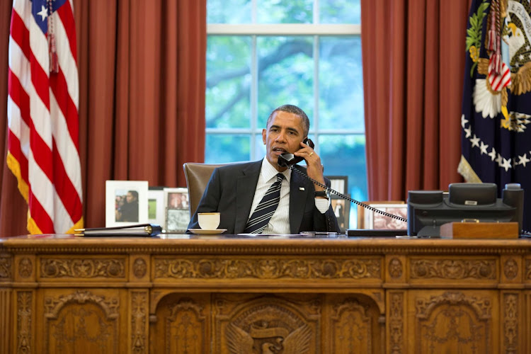 U.S. President Barack Obama talks with Iranian President Hassan Rouhani during a phone call in the Oval Office at the White House in Washington September 27, 2013.