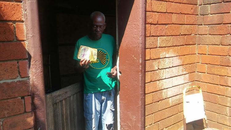 Mokhethi Mochesane, 73, of Sharpeville shows a dompas which he received in the 1970s and keeps in memory of the fight against apartheid laws. Mochesane lives alone in his house and still endures the pain of a bullet lodged in his left leg which he took in 1960 when the police opened fire on protesters. He was just a teenager.