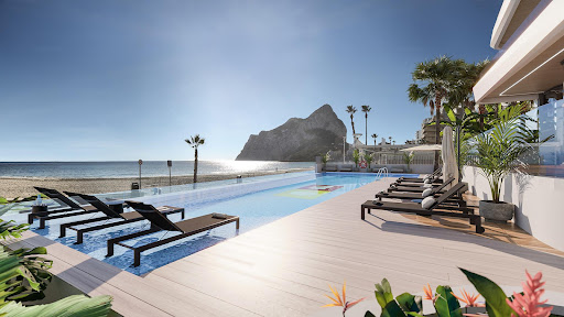 Infinity pool facing the sea, lounge chairs in this luxury apartment / penthouse for sale in Calp ($1,220,359 - 125 m²)