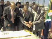 HAPPY BIRTHDAY: Former executive mayor of the Mopani district in Limpopo Humphrey Mokgobi, left, current executive mayor Joshua Matlou, and local government and housing MEC Soviet Lekganyane cut a cake to celebrate Nelson Mandela's 91st birthday in Bolobedu on Saturday. Pic: MICHAEL SAKUNEKA. 19/07/2009. © Sowetan.