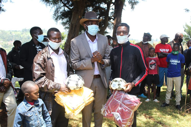 Nyamira County Assembly Majority Whip Duke Masira donating uniforms and balls to teams in Nyamira town.