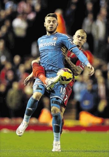 tussle: Connor Wickham of Sunderland battles for the ball with Martin Skrtel of Liverpool during their Premier League match on Saturday Photo: Scott Heavey/Getty Images