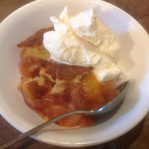 Nectarine cobbler topped with homemade vanilla ice cream. 