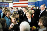 CAMPAIGN TRAIL: Democratic presidential hoeful Hillary Clinton greets supporters during a meeting in Knoxville, Iowa. Clinton told voters htat the economy needed help and fast, and she had the experience to do the job. Pic. Charlie Neilbergall. 19/11/07. © AP.