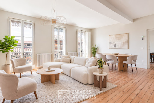 Buy this luxury property in Toulouse (31000) - Living room with white sofa and dining table