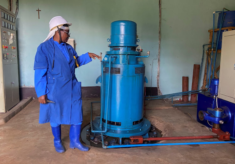 Congolese nun and electrical engineer Alfonsine Ciza walks past the alternator at her micro hydropower plant that provides electricity to a convent, schools and a health centre in Miti near Bukavu South Kivu in the east of the Democratic Republic of Congo on April 12, 2022.