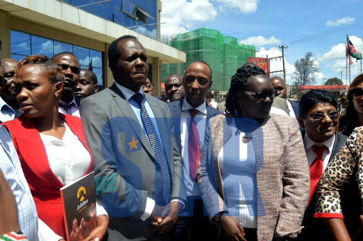 Jubilee party secretary general Raphael Tuju (Second, Left in front row) with Nairobi county Majority Leader Abdi Guyo (with red tie) and other party MCAs on Wednesday, October 16, 2019.