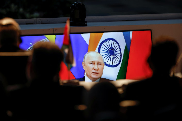 A screen shows Russian President Vladimir Putin virtually delivering remarks during the 2023 Brics Summit at the Sandton Convention Centre in Johannesburg on August 24. Picture: REUTERS/MARCO LONGARI