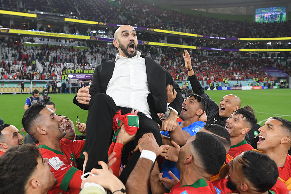 Morocco coach Walid Regragui is held aloft by his players at the end of the World Cup quarterfinal match against Portugal at Al Thumama Stadium on December 10 2022 in Doha, Qatar. Picture: MIKE HEWITT/FIFA VIA GETTY IMAGES