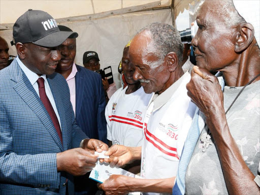 Deputy President William Ruto talks with residents during the International Day of Older Persons celebrations at Gusii Stadium, Kisii county on October 6, 2016. /DPPS