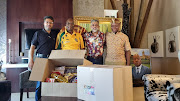 Imraan Vally, director of CK Tobacco, former president Jacob Zuma, Yusuf Kajee and Edward Zuma in Nkandla with some of the food to be distributed.