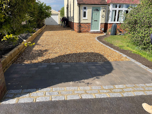 Lovely Granite set with Grey Alpha block paving finished with 20mm shingle driveway