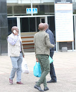 Lucas Mthembu, Khayalihle Mzila and Silence Mkwakwa, all bodyguards for the Mayor of Mandeni, leave the Durban Magistrates court after appearing on firearm charges.