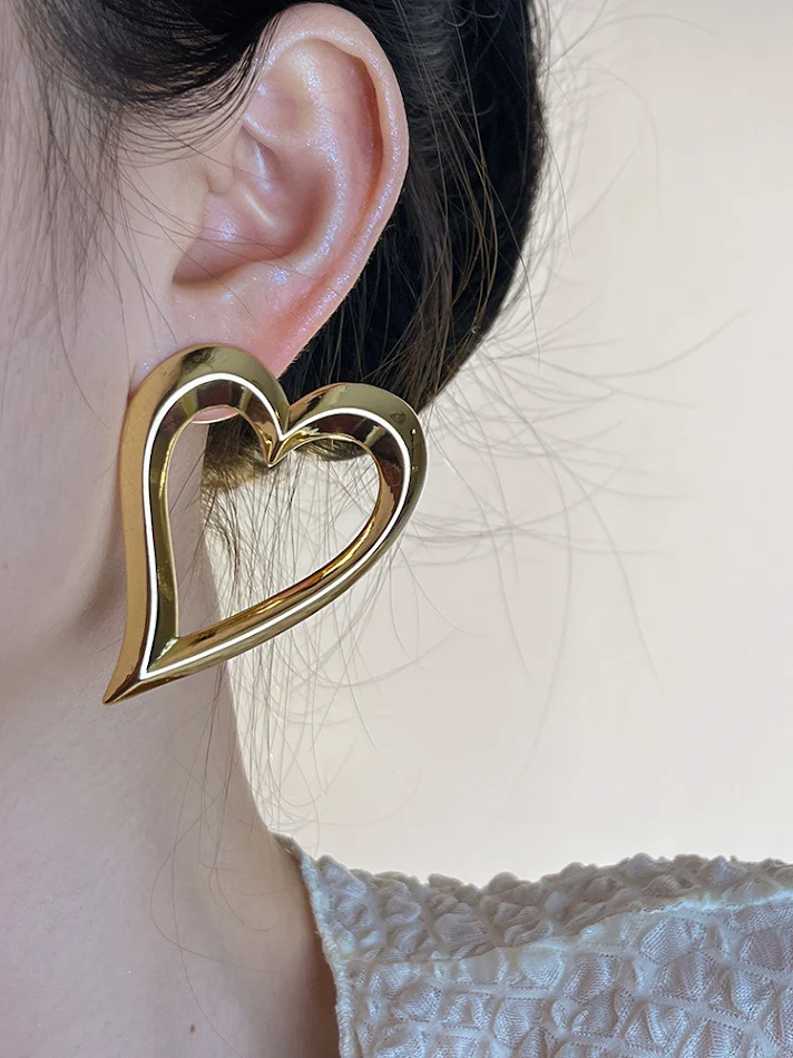 Boucles d'oreilles cœur creux en métal, design accrocheur pour l'été, style européen et américain, parfaites pour un look estival unique et tendance.