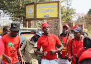 EFF members protesting outside Crowthorne Christian Academy in Midrand following the suspension of a teenage girl because of her natural dreadlocks.