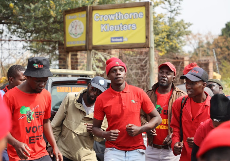 EFF members protesting outside Crowthorne Christian Academy in Midrand following the suspension of a teenage girl because of her natural dreadlocks.