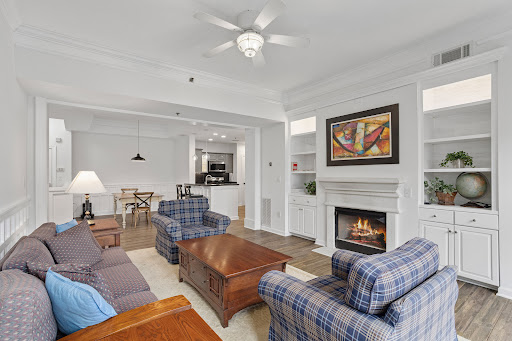 Property purchase in Atlanta (United States) - Living room with sofa, armchairs, and fireplace