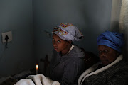 Nkule Khenisa and Thozo Shabalala mourn Sanele Khenisa, who was among those shot dead.