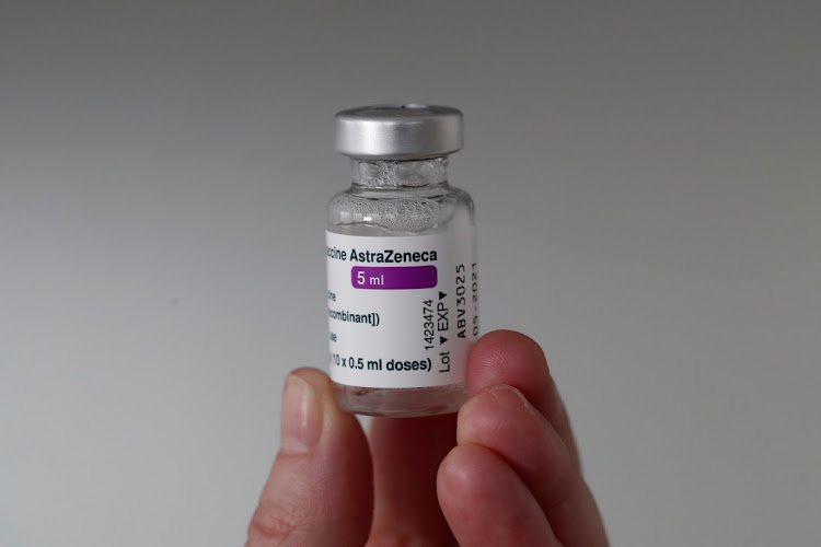 A member of the medical staff holds a vial of the Oxford-AstraZeneca COVID-19 vaccine at the Foch hospital in Suresnes, near Paris, France, February 8, 2021.