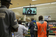 South Africans watch as President Cyril Ramaphosa addresses the nation over the coronavirus and Covid-19 pandemic on Monday night.