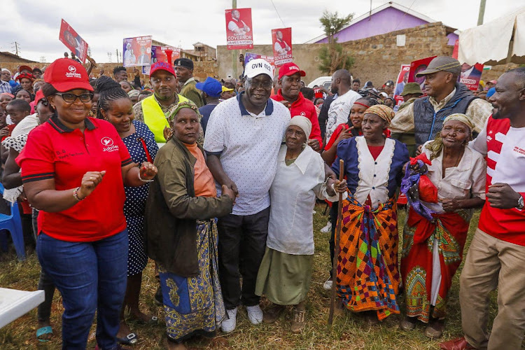 Kiambu Governor James Nyoro with Umoja slums residents in Thika on Tuesday.