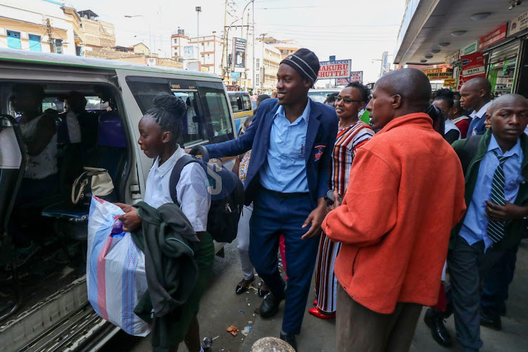 Learners board a matatu at Tea Room bus station on Wednesday, January 25.