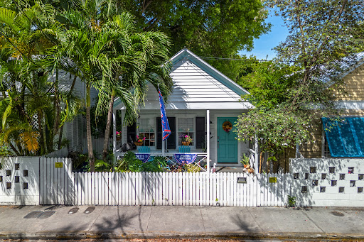 Buy this luxury house in Key West (United States) - White house with white fence and vegetation