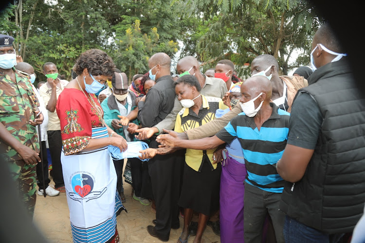 Kitui governor, Charity Ngilu, distributes free face masks to residents on Mutomo market iin Kitui South last Friday.