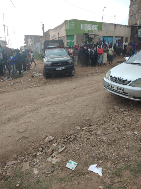 Residents mill around the scene where two police officers were shot dead by thugs at Obama area in Kayole, Nairobi on Friday November 8.