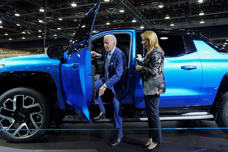 US President Joe Biden steps out of an electric Chevrolet Silverado pickup truck watched by GM CEO Mary Barra in Detroit, Michigan, the US, September 14 2022. Picture: KEVIN LAMARQUE/REUTERS