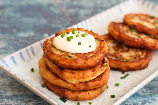 Sour cream on top of the Cheesy Parmesan Potato Pancakes.