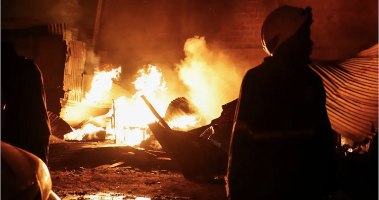 Firefighters at the scene of an explosion at a makeshift gas cylinder refilling depot in Mradi estate, Embakasi district of Nairobi