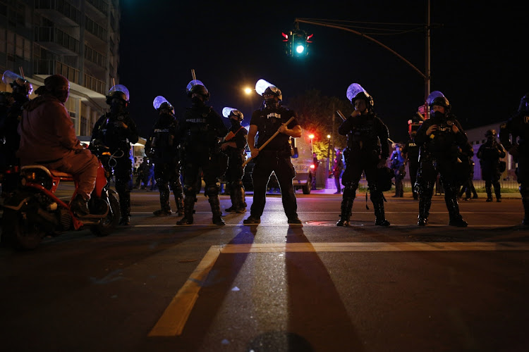 Police officers block off an intersection outside First Unitarian Church during a protest in Louisville, Kentucky, US, on Thursday, September 24, 2020. Wednesday's decision not to charge Kentucky police officers for the killing of Breonna Taylor ignited a fresh wave of protests in the US.