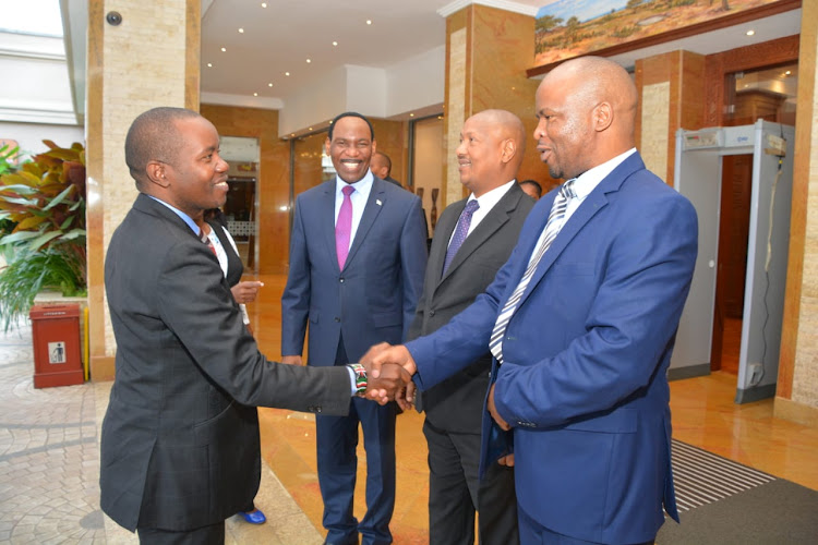 ICT Cabinet Secretary Joe Mucheru is welcomed for the launch of the Media Landscape Report by the TIFA managing Director Gerry Kweya.