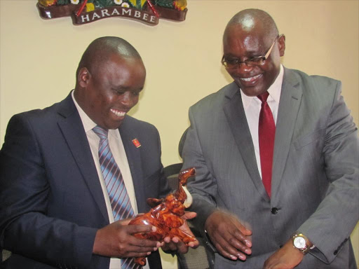 Elgeyo Marakwet governor Alex Tolgos admires a soapstone sculpture he was given by his Kisii counterpart James Ongwae in his office when he paid him a courtesy call on May 6.Photo/BENSON NYAGESIBA