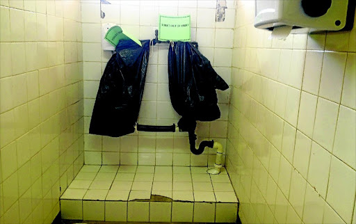 Black refuse bags cover urinals that are out of order at a police station in North West. /Tiro Ramatlhatse