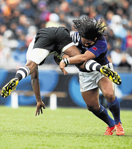 Samoan vice-captain Seilala Mapusua makes a big tackle during the match against Fiji at Eden Park on Sunday. Samoa won the Pacific Islands derby 27-7 Picture: STEVE HAAG/GALLO IMAGES