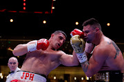 Justis Huni throws a left at Kevin Lerena. 