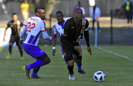 Royal Eagles's Philani Cele challenged by Mohau Mokate of Maritzburg United.