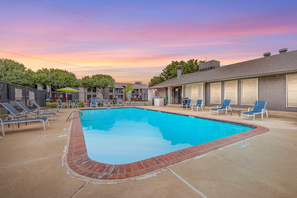 Swimming pool with lounge chairs at dusk