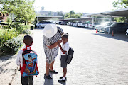 Natalia Nqabeni wipes tears from her daughter Khayone Poro's eyes on the first day at school. 