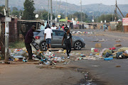 Atteridgeville residents navigate roads strewn with rubble and rocks during the national shutdown called by the EFF.  