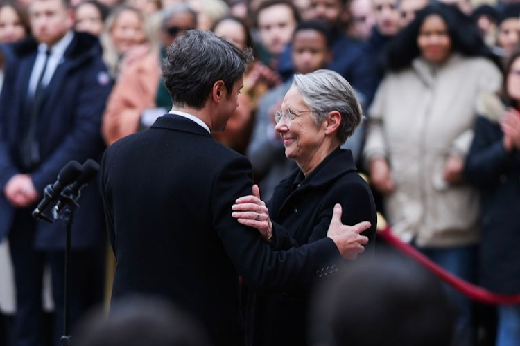 Gabriel Attal as the new French Prime Minister hugs predecessor Élisabeth Borne.