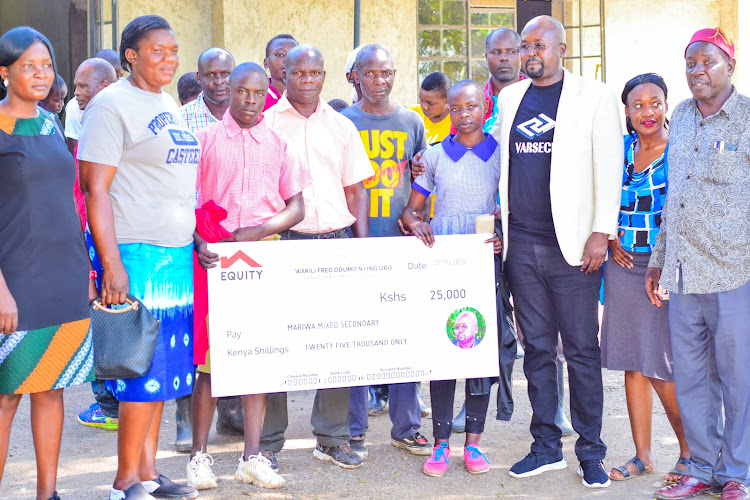 Advocate Fred Odumo Nying'uro with students during the first phase of his programme for paying fees to Day school students.