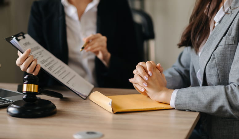 a workers comp attorney reviewing paperwork with a client