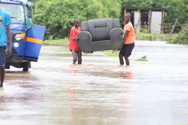 Residents of Tura village in Nyando relocating to safety after their homes were marooned by flood waters after River Nyando broke it's banks on May 1,2023.