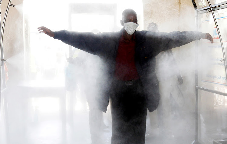 A passenger walks through a disinfection tunnel at the main railway station in Nairobi, Kenya. An SA chemist has warned against such tunnels.